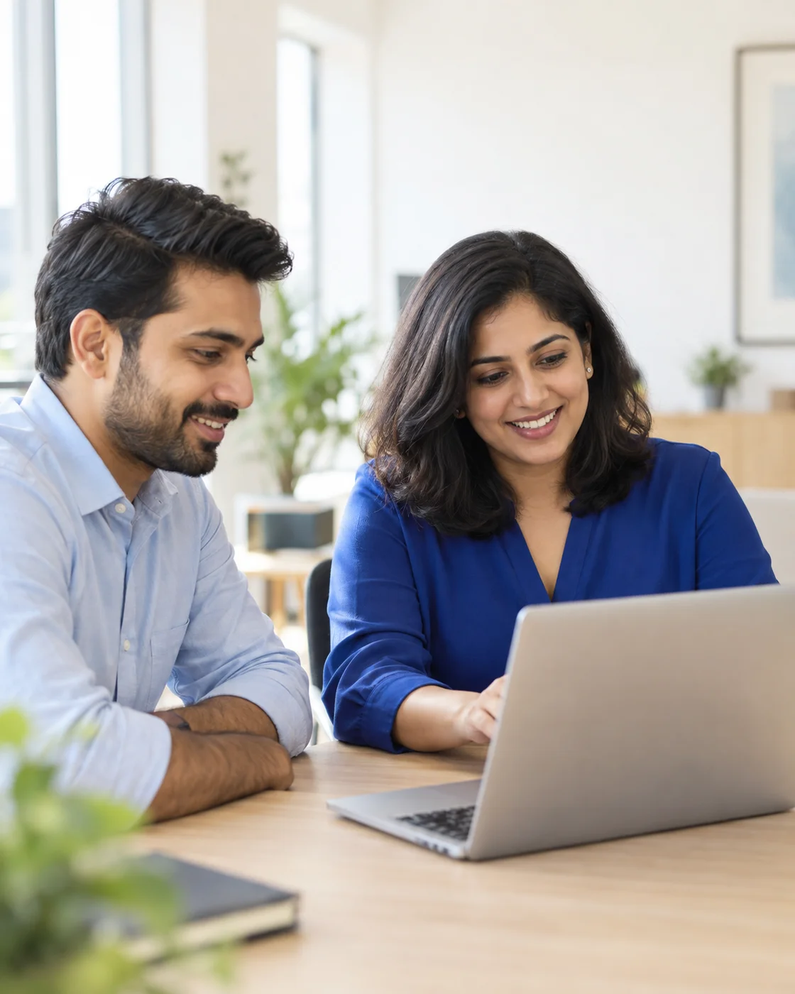 Recruiting colleagues discussing their next hire at a laptop